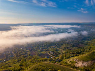 River scenery in the early morning. A hut in far away, and the tree covered by mystical fog, very quiet and tranquil.