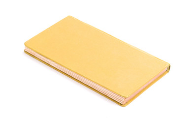 Closed old yellow book isolated