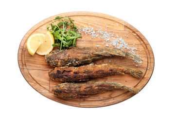 .fried fish on a wooden board isolated on white background