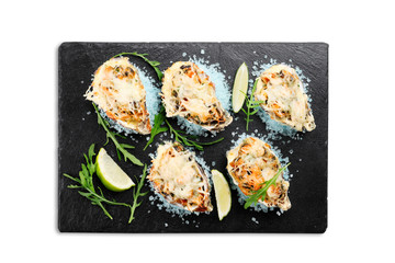 seafood on blue sea salt with .cheese and lime on a slate plate isolated on white background