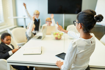 Teacher at a school with students in the classroom