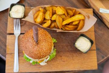 Delicious cheeseburger with wedges