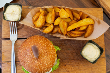 Delicious cheeseburger with wedges