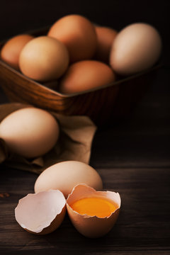 Close-up Of Organic Eggs, Against Dark Brown Wooden Background.