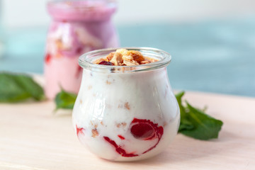 Granola with yogurt and berries for healthy breakfast on a table