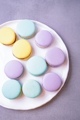 Mint, purple and yellow macarons or macaroons dessert. Copy space, top view