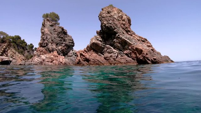 Rocky islets near coast seen from water surface, Mediterranean sea, Spain, Costa Brava, Catalonia, Calella de Palafrugell