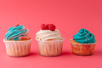 Tasty cupcakes sweets on pink background close up