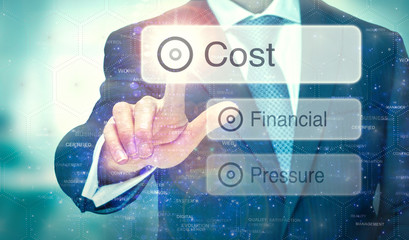 A businessman selecting a button on a futuristic display with a Cost concept written on it.
