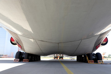 belly of an airplane standing in the parking lot close up