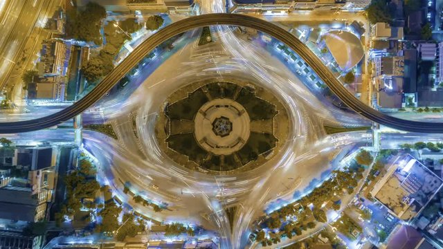 aerial top view traffic road roundabout in city at night, Time lapse top road in bangkok.