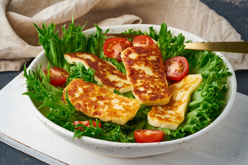Healthy salad with fried halloumi and tomatoes, closeup, keto ketogenic diet