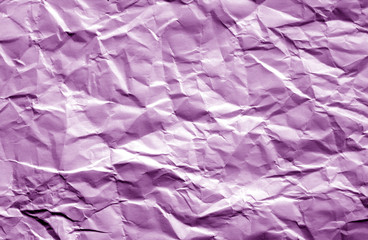 Crumpled sheet of paper with blur effect in purple color.