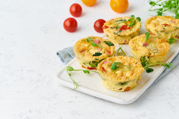 omelet with tomatoes and bacon, baked eggs with spinach and broccoli, closeup with copy space, keto, ketogenic diet