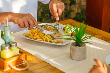 Traditional Montenegrin Meat Negush Steak on white plate in a restaurant.
