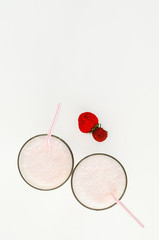 Strawberry cocktail or milk shake in a glass decorated with strawberries on the table. Healthy food for breakfast and snacks.