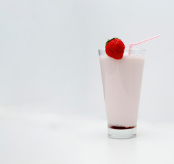 Strawberry cocktail or milk shake in a glass decorated with strawberries on the table. Healthy food for breakfast and snacks.