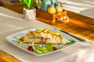 Traditional Montenegrin Meat Negush Steak on white plate in a restaurant.