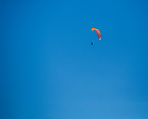 Paraglider isolated against a blue sky