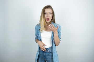 young beautiful woman lookes surprised isolated white background