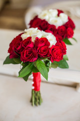 Wedding bouquet of red and white roses on a light background