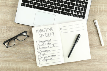 Digital marketing strategies concept. Hand written marketing plan. Close up, copy space, top view, flat lay, background.