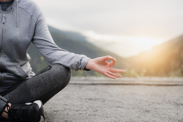 Woman practices yoga at sunset. Concept Sports and recreation.