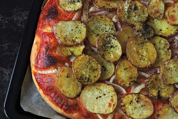 Homemade potato pizza. Square pizza with potatoes. Vegan pizza.