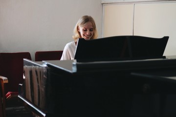 young woman playing the piano © Lera