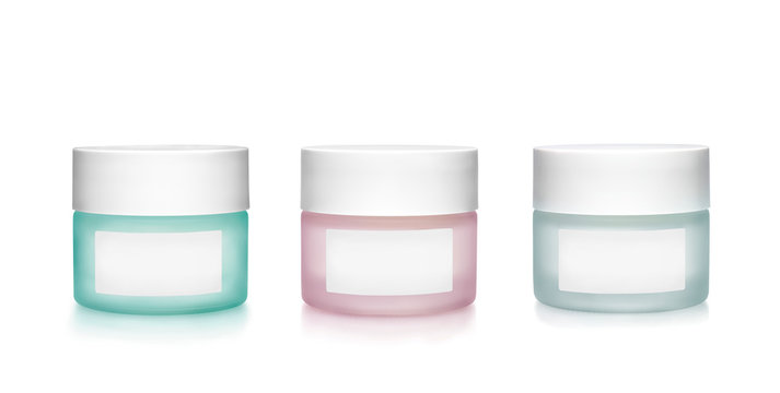 Frosting Glass Cosmetics Containers With Blank Labels Against White Background