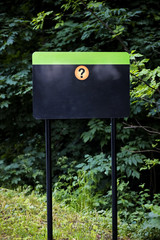 Blank black signboard with a question mark  in the park