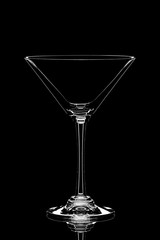 Transparent empty glass of martini isolated on black background