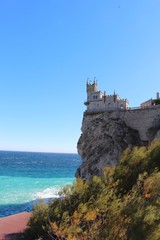 Fototapeta na wymiar View of The Swallow's Nest. It's s a decorative castle located at Gaspra in Crimea. It was built between 1911 and 1912, on top of the 40-metre high Aurora Cliff.