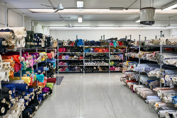 Fabric warehouse with many multicolored textile rolls