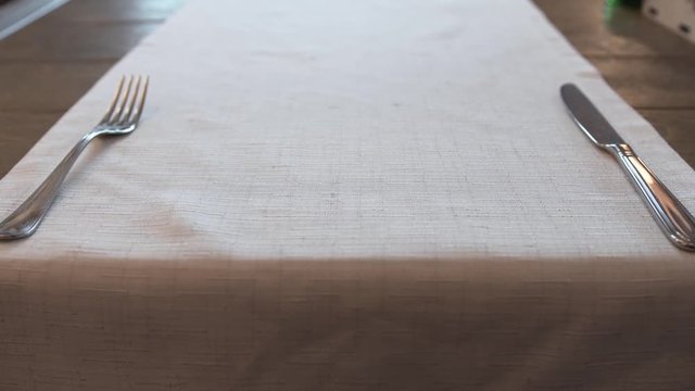 metal fork and knife on a napkin on the table