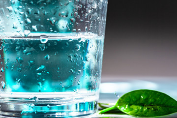 Served table set of mineral water bottle and glass