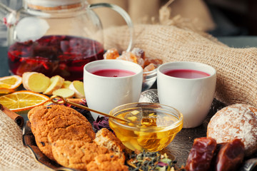 Cup of freshly brewed fruit and herbal tea, dark mood.Tea ceremony
