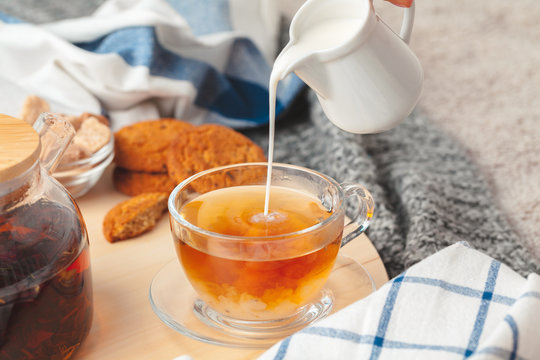Hot masala chai, tea with milk poured over close up