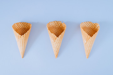 Ice Cream Cones on blue background, flat lay, minimalism