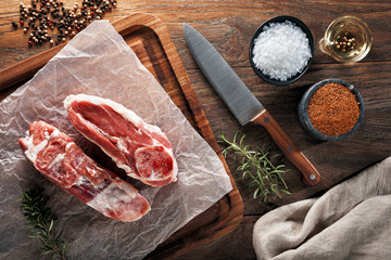 Raw lamb stew on white cooking paper and wooden cutting table