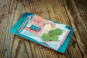 payment on the bill in a cafe on a plate on a wooden table