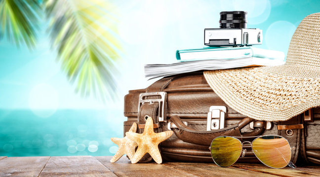 Summer suitcase and beach landscape with sea and coconuts 