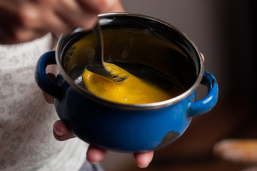 A blue metal bowl with a fork and  egg