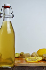 Homemade fermented raw kombucha tea with different flavorings. Healthy natural probiotic flavored drink with lemon and ginger or ginger ale. Copy space.