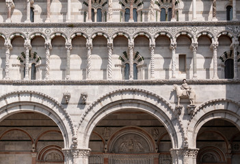 Fototapeta na wymiar The facade of Lucca Cathedral, a Roman Catholic church dedicated to Saint Martin of Tours. The cathedral is on Piazza San Martino, a square dedicated to the same saint.
