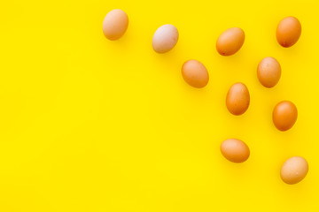 Blog pattern with eggs on yellow background top view copyspace