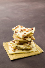hazelnut white chocolate pieces on brown background