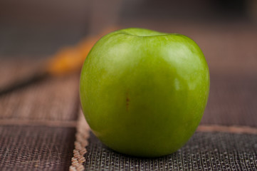 Beautiful green apple with knife on the kitchen table.Green fruit