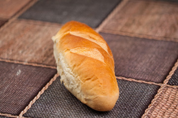 Homemade bread and knife on the kitchen table.Tasty food