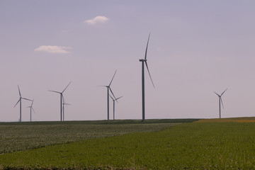 Fototapeta na wymiar Wind turbine towers installed on agricultural fields